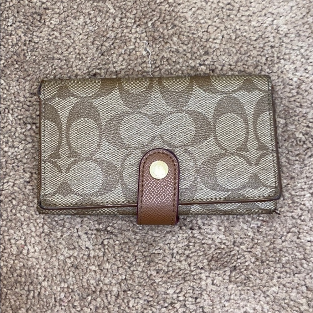 Coach tan and brown wallet.